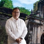 Photo of DoT Sec Ramon Jimenez in front of Intramuros