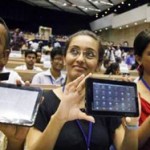 Photo of audience of students holding up their tablets