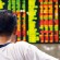 Photo of Filipino man looking at stock monitor