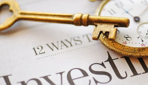 Photo of skeleton key and pocket watch on financial newspaper